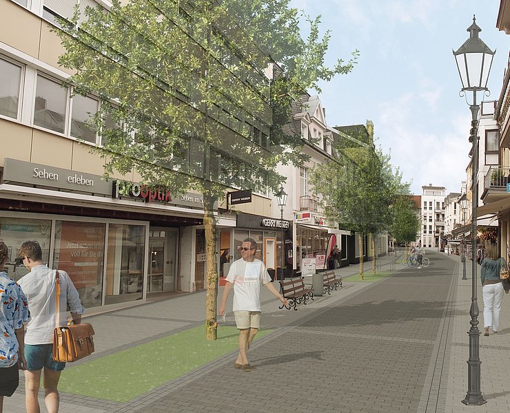 Besucherinnen und Besucher spazieren durch die neue Poststraße.